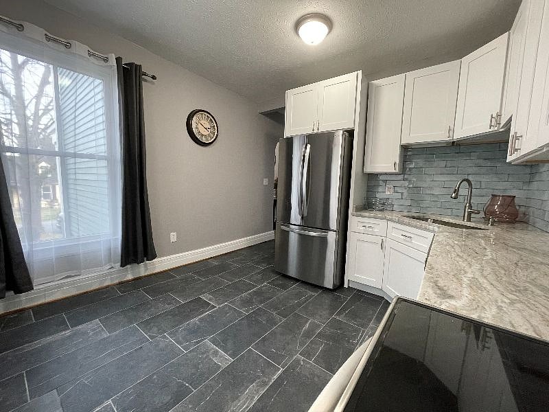 Kitchen refrigerator has large storage capacity and ice maker.