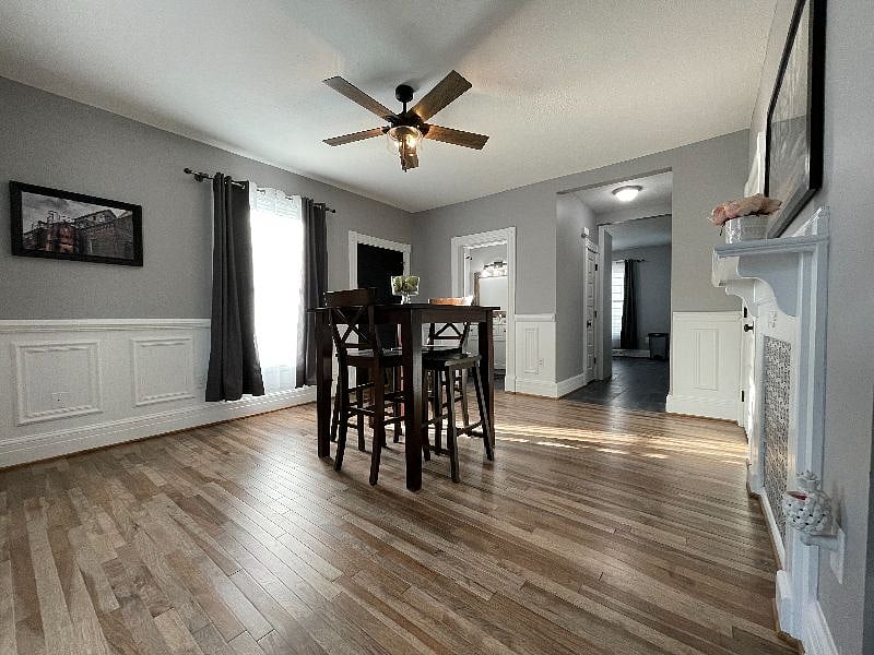 Dining room has a pub style table with 4 chairs for eating or socializing.