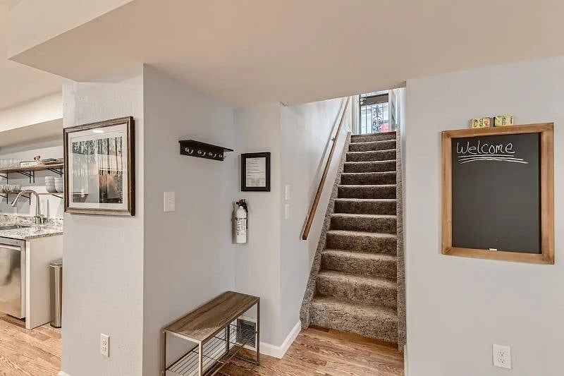 Simple Entry into open concept. Large pantry/closet featured where coat rack and picture are located