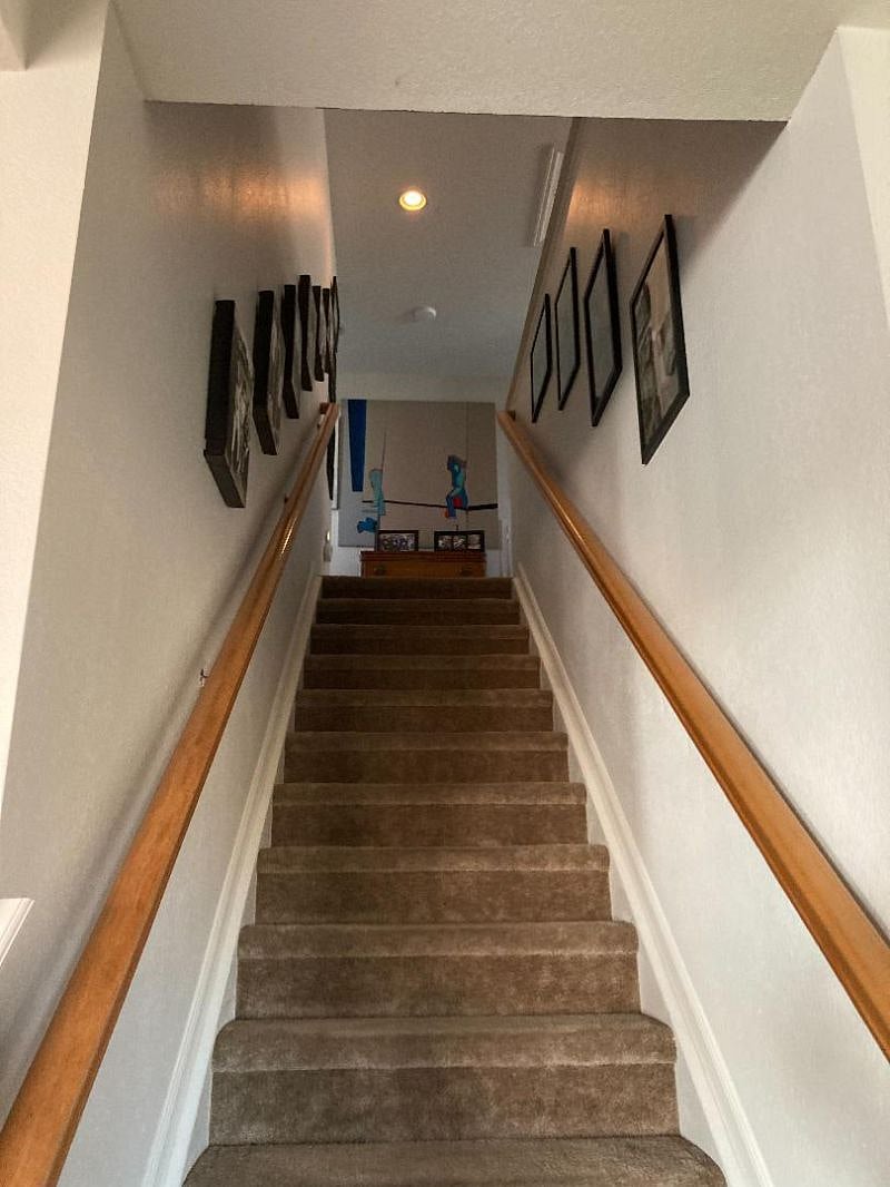Stairway up to smartspace. Draped/blind opening for more privacy if desired. From experience it is significantly removed from rest of house. Especially the bedroom which has a door that can be closed. 
