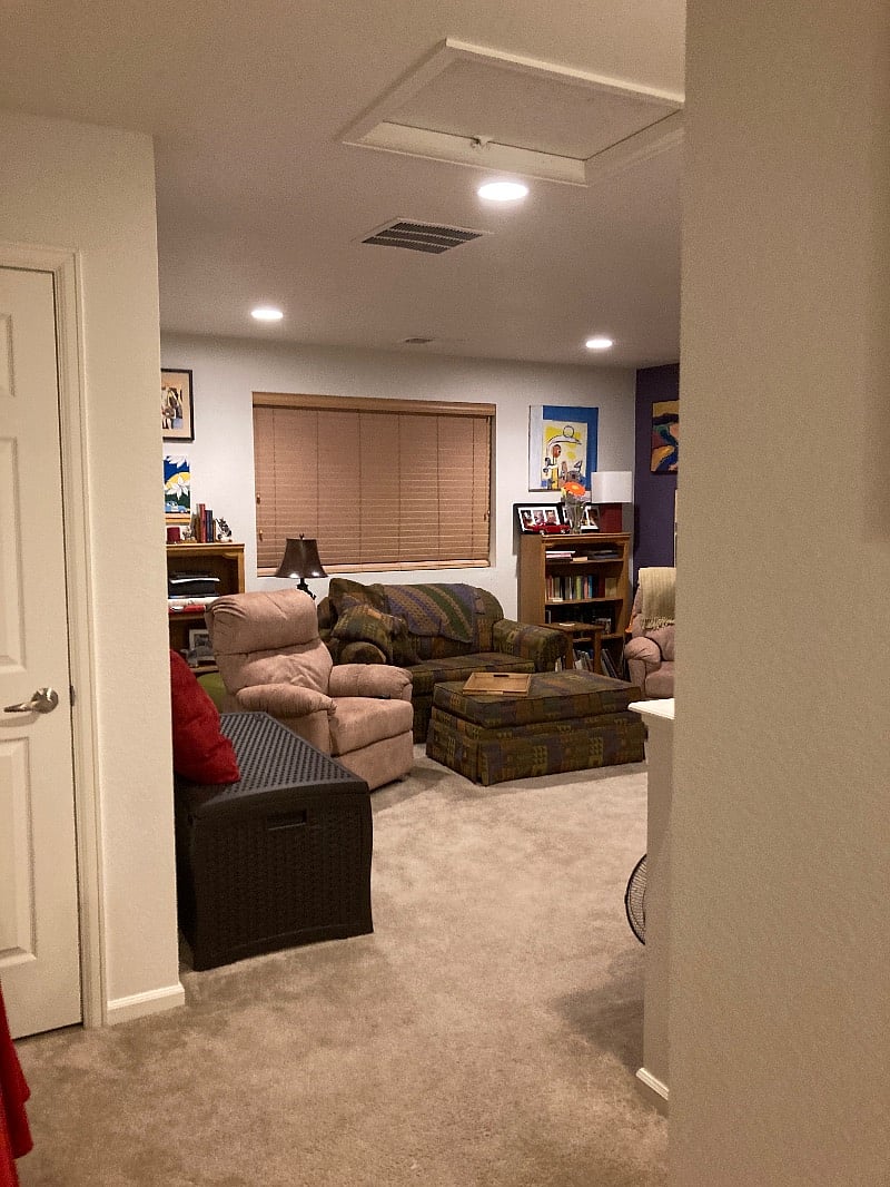 Looking at living area from bedroom door (looking right from top of stairs).