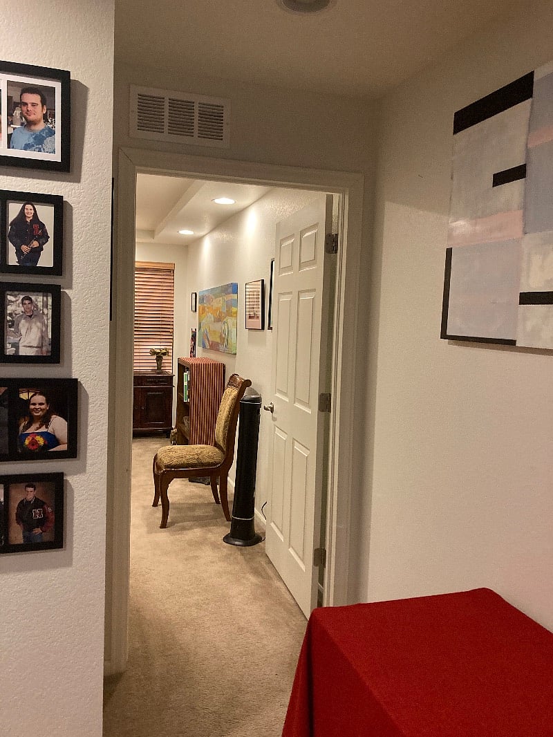 Top of stairs looking left into bedroom from living area