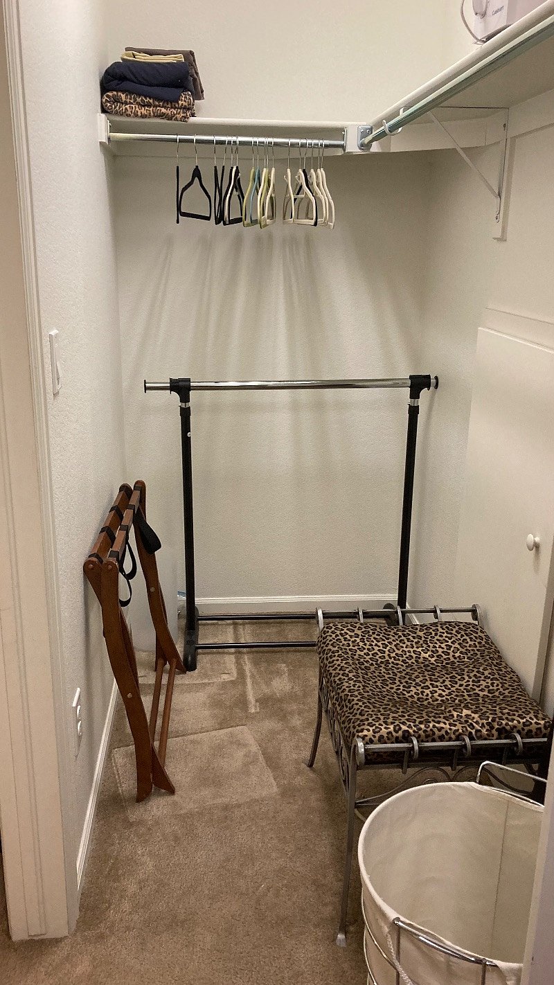 Photo got cropped.There is a shelf across the end and right side. There is a hanging bar 6' across the right side. Door to the bedroom is on the left. There is ample storage in this space, a dressing seat and a luggage rack. 