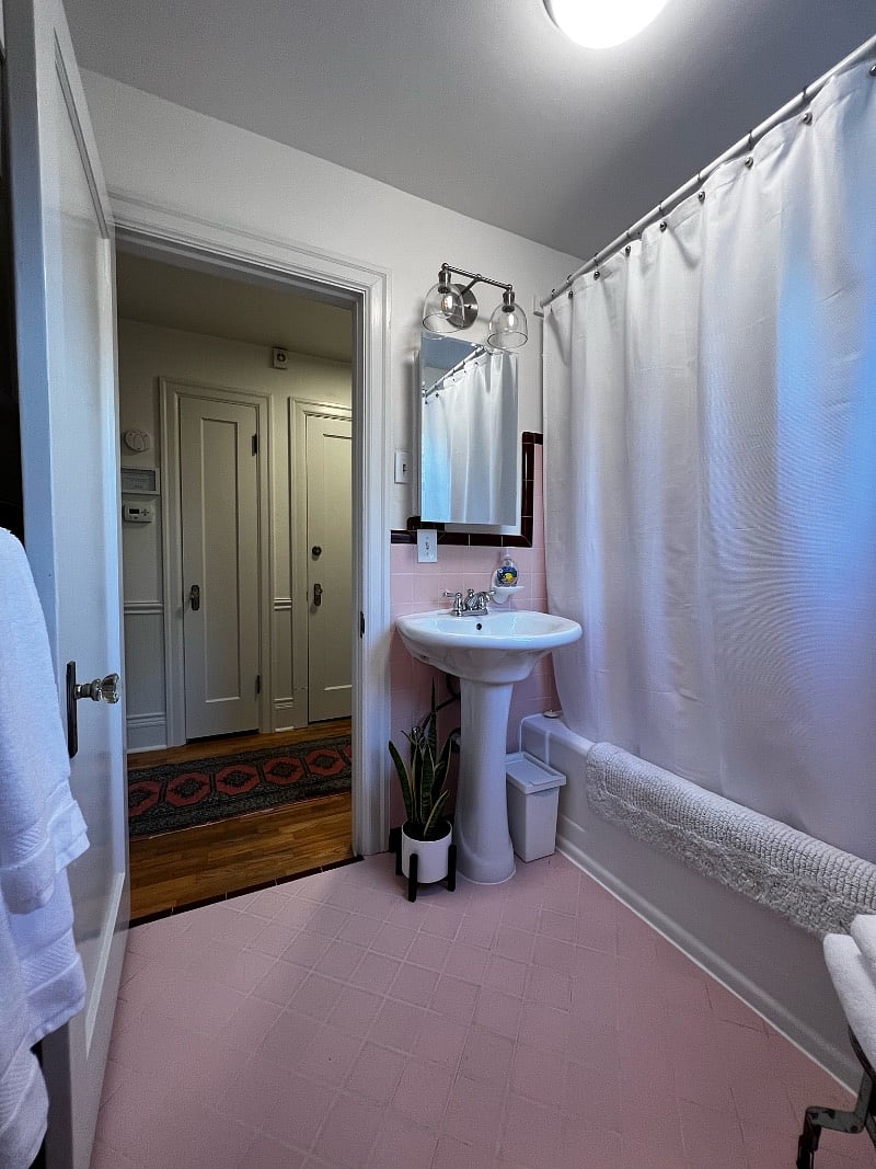 Full bathroom with shower / bathtub and bright light. Blow dryer located in hallway linen closet.