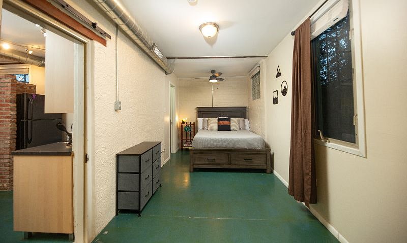 Bedroom view from entry door and office area.