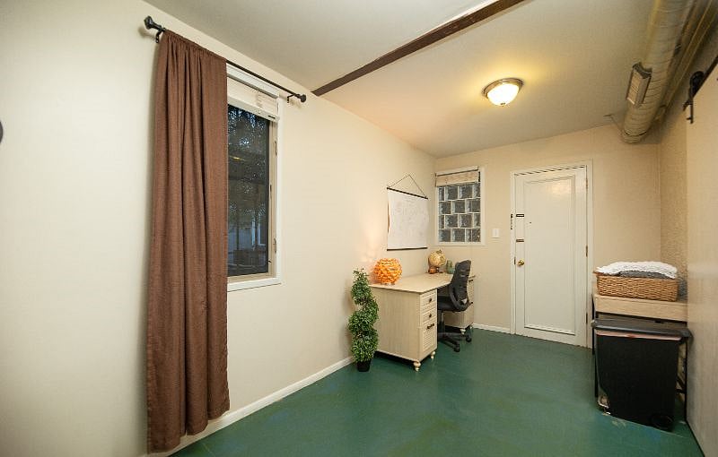 View from bedroom entry toward office area & side entry door. This exit will take you to the laundry room about 20 ft away.