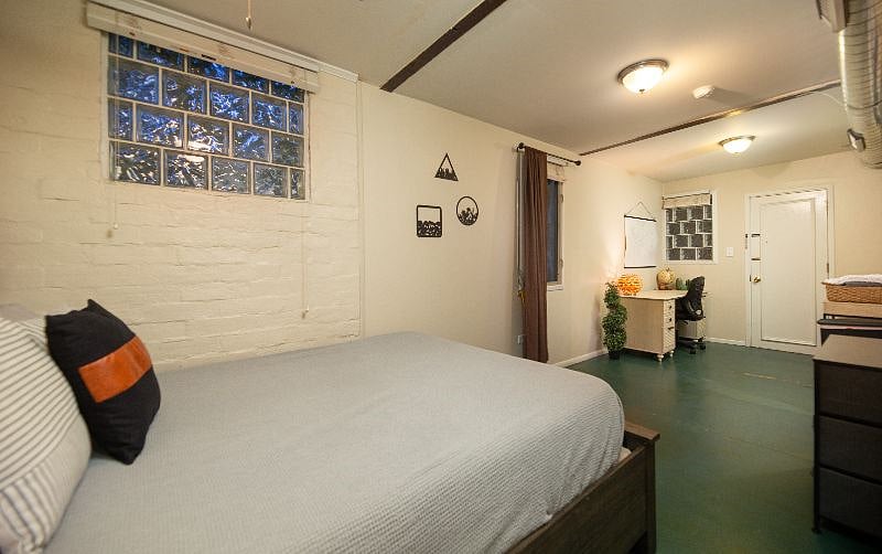 View from bedroom area toward office area and side entry.