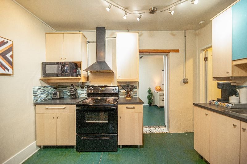 View of kitchen towards bedroom entry (directly ahead) & bathroom entry (to the right).