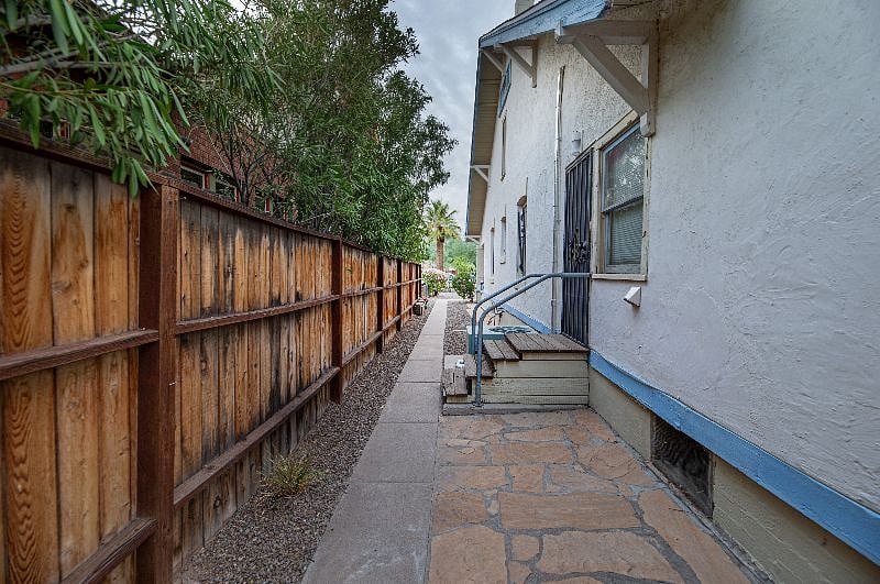 View from Apt D's side exit from the office area. The stairs are the laundry room entry. This walkway leads to the street parking on the front of the property.