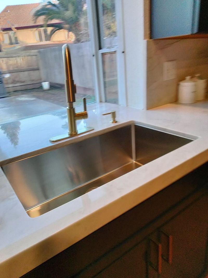 Kitchen sink with bay window view of backyard.