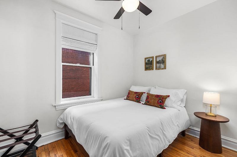 This bedroom right off the dining room features a queen sized memory foam mattress, nightstand, lamp, and sound machine