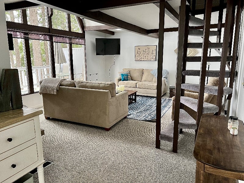 Living room with Smart TV and with stairs to the loft.