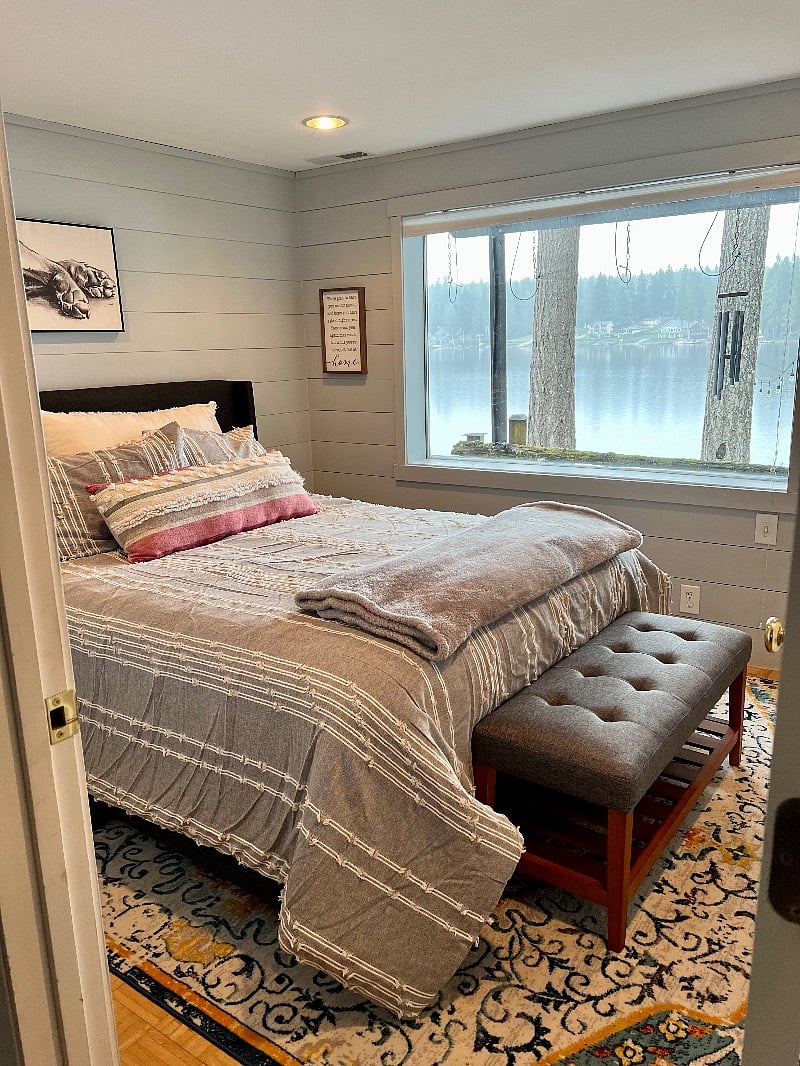 Downstairs bedroom with queen bed and a lake view.