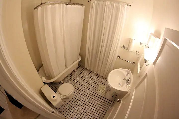 The bathroom is on the first floor and has a sink, toilet and classic clawfoot tub.