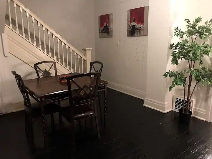 The dining area includes a four-piece dining table set.