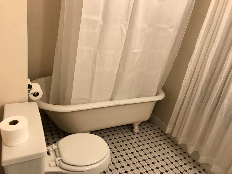 The bathroom is on the first floor and has a sink, toilet and classic clawfoot tub.