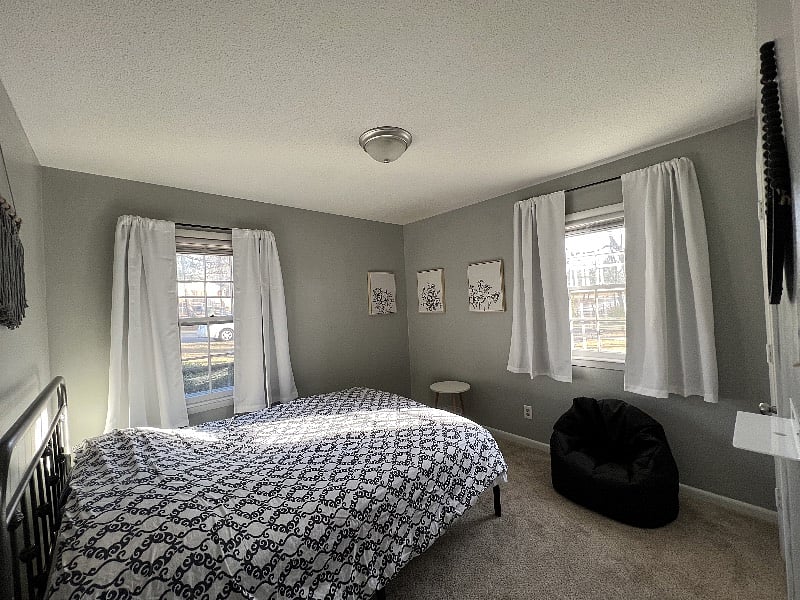 Secondary bedroom, large closet, comfy bed with blackout curtains, typical afternoon natural light shown here.