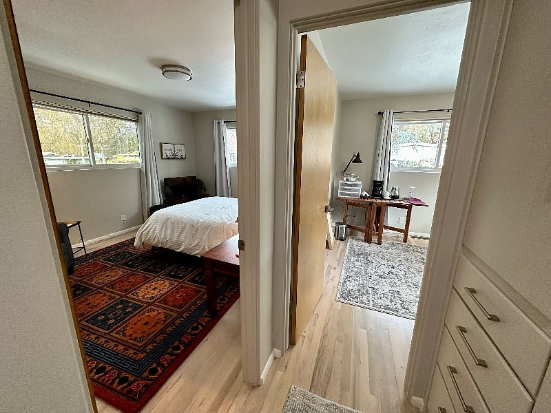 hallway view of the bedroom on the right and the office/kitchenette on the right