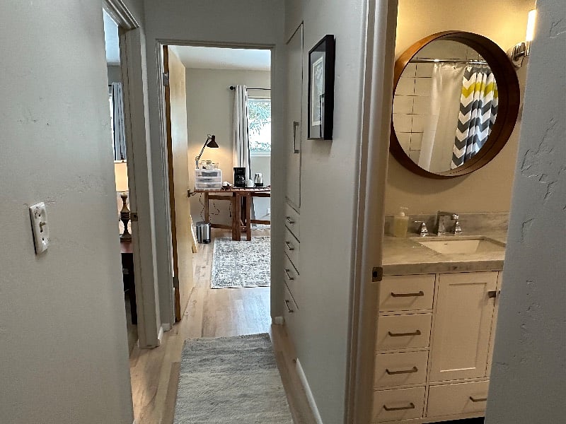 hallway with more storage, bathroom on the right