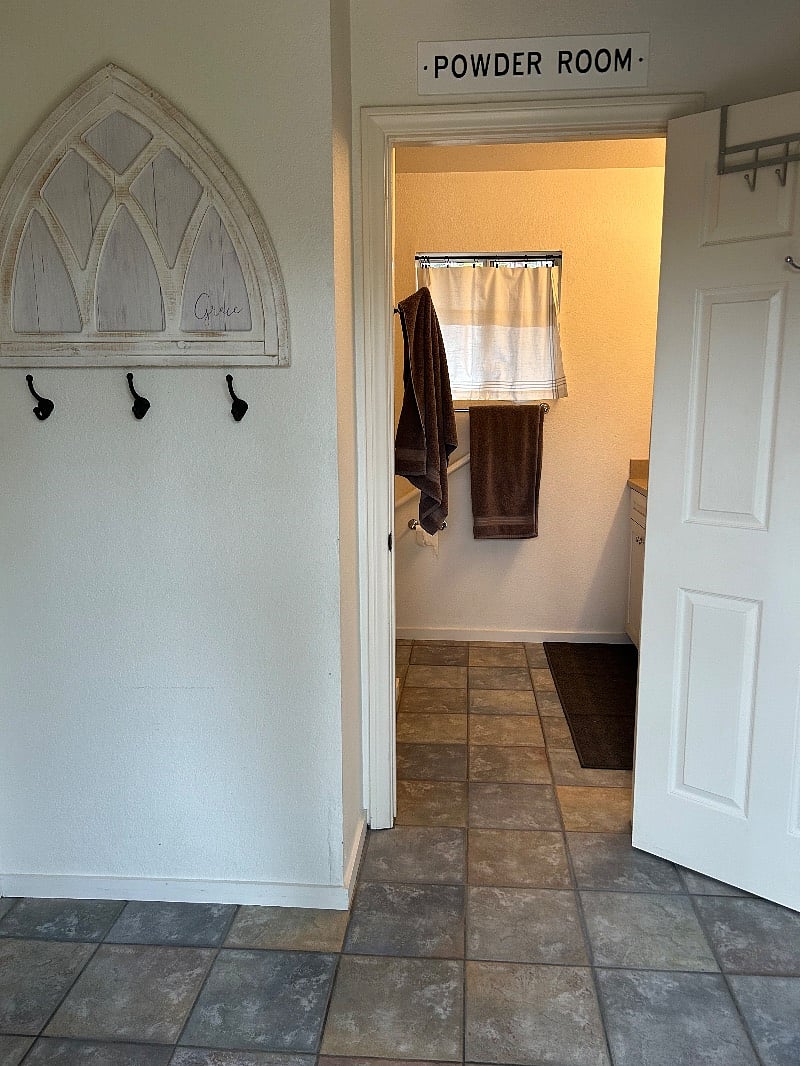 Just inside front door. Bathroom straight ahead. Kitchenette/dining area, living room to the right and bedroom to the left
