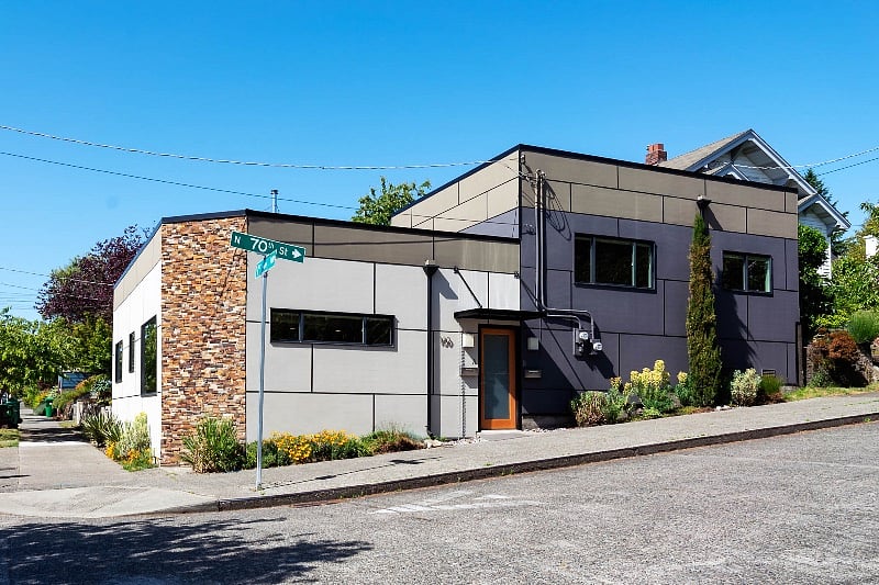 Exterior of duplex, shared entry door.  Unit B goes upstairs, and is the dark grey portion of the building.  Right hand window is south bedroom, and left  window is the living room.