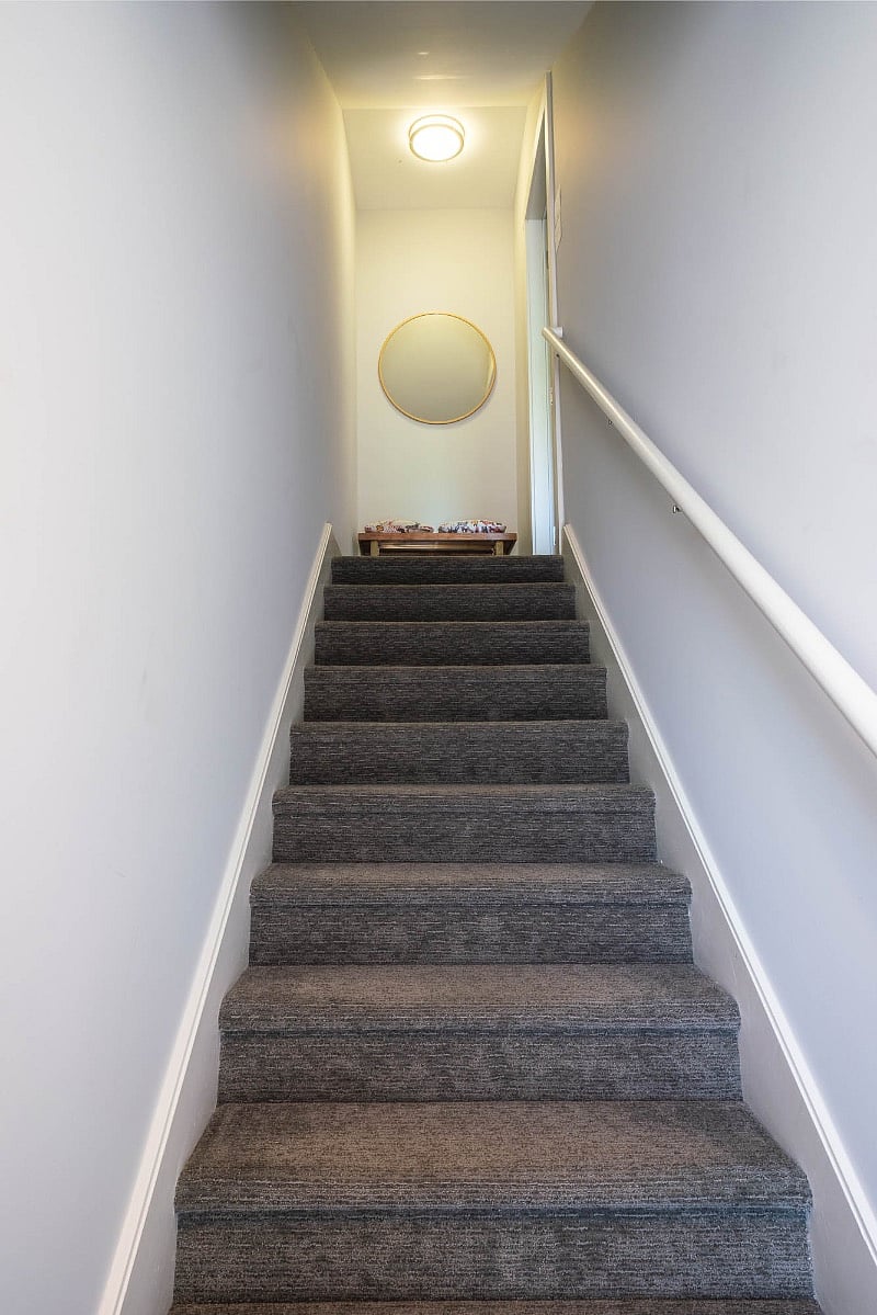 Stairs to front door of unit B - shoe rack and bench provided at the top of the stairs.  Front door is to the right.