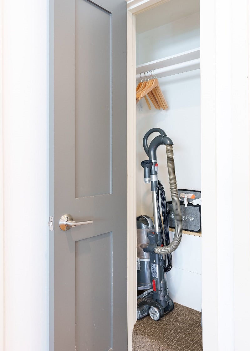 Front coat closet with vaccu and spare folding chair.