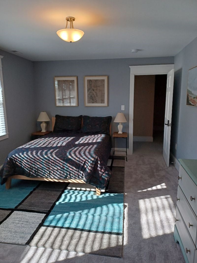 This is the 'back' bedroom has a queen size bed and large closet. It has exclusive use of a private bathroom (tub/shower) accessed via the hallway.