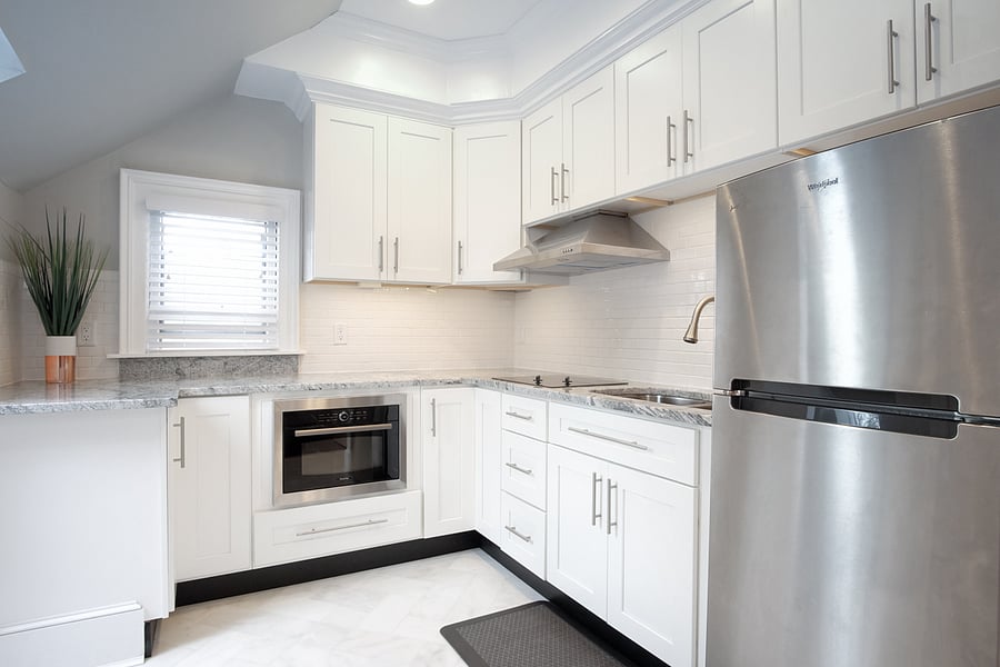 Fully stocked kitchen with cooking supplies and meal eating area.
