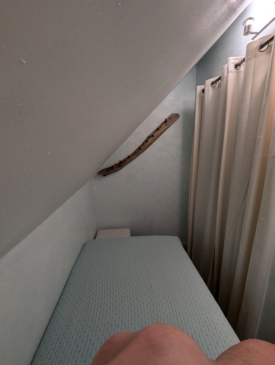 Tiny sleeping nook (Harry Potter style!) with twin bed.