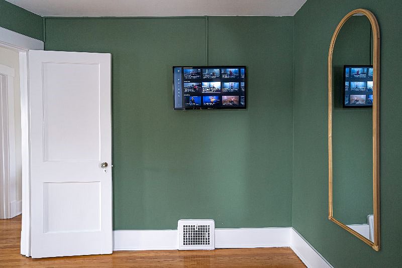 Mounted television to stream workouts in home gym