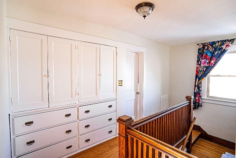 Original built-in dresser and wood banister