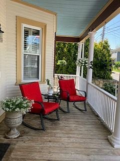 Front farmers Porch, rocking chairs with side table. 
