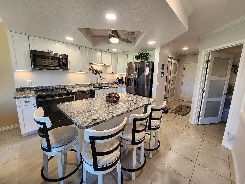 Remodeled kitchen with new cabinets, leathered granite countertops, and new appliances.