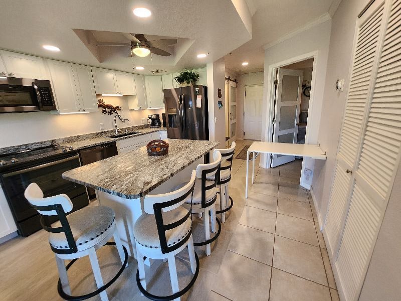 Kitchen area also has a desk - or table-height dining for two, that folds up onto the wall when not in use.