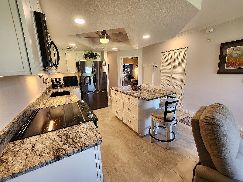 Kitchen view to the 2nd bedroom, fold up desk/table, and w&d and cleaning supply closet.