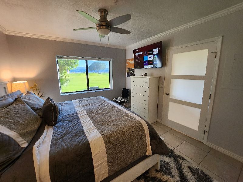 Primary bedroom with new furniture, including a very comfortable king bed with a view onto the golf course and out to the lake.