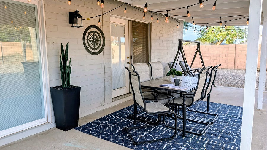Relax under the covered patio with outdoor dining and a cozy swing.