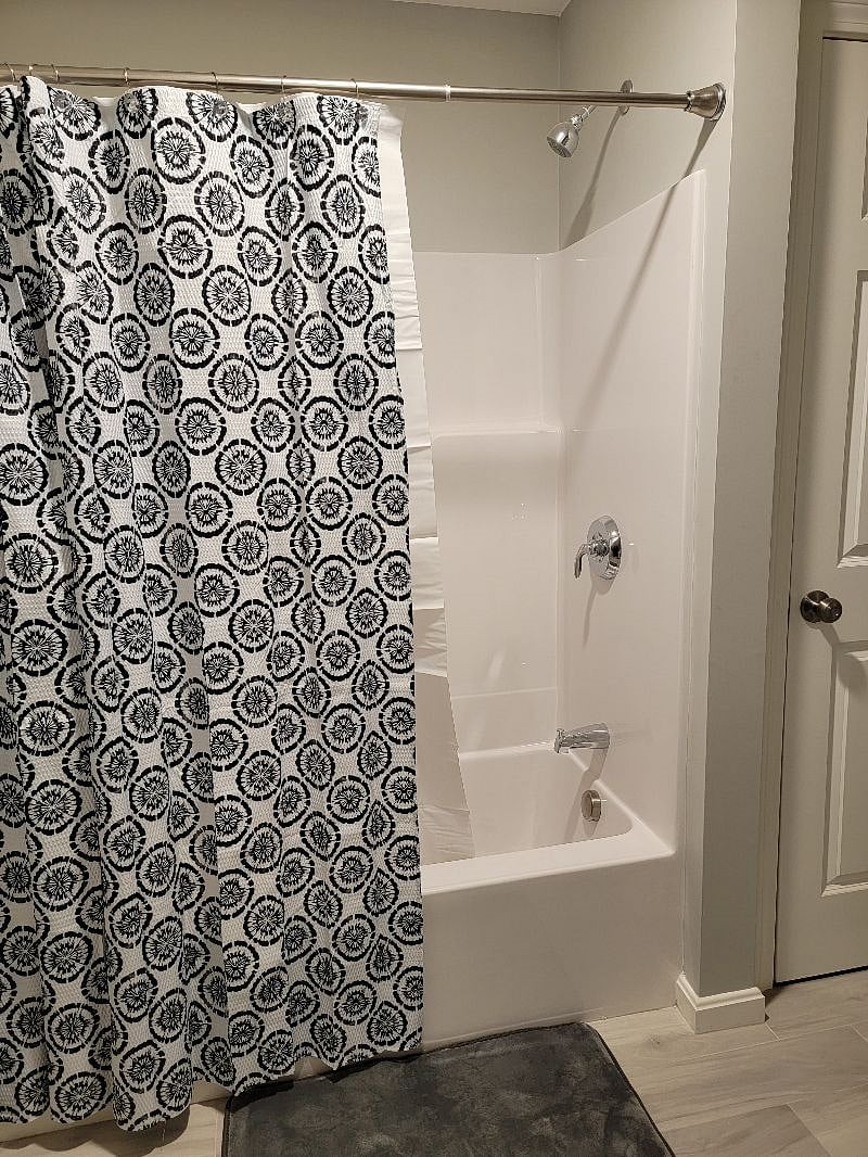 Shared Bathroom tub & shower. Very spacious and a lot of cabinets to store away bathroom utilities