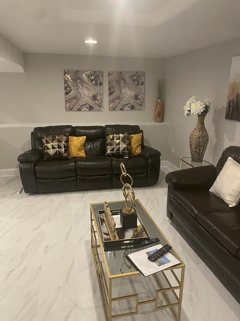 View of living room. Floor was recently updated with beautiful porcelain tile for a modern appeal and ease of use.
