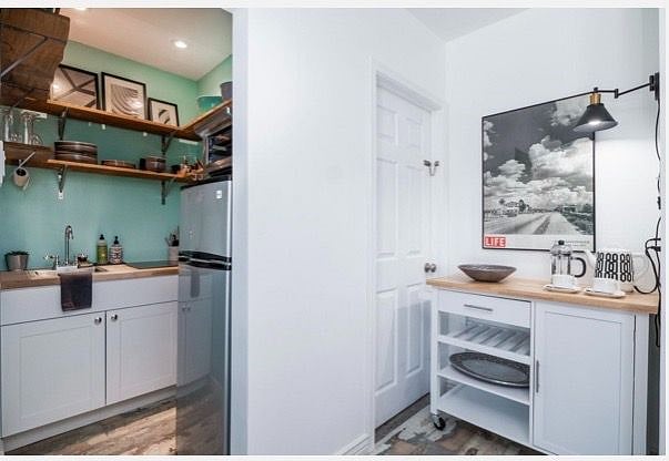 Kitchenette + door to the shared laundry room (laundry on assigned days)
