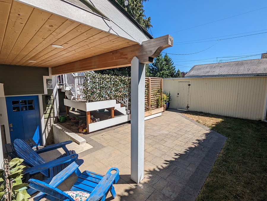 Private back patio with covered seating (showing entrance and gate)