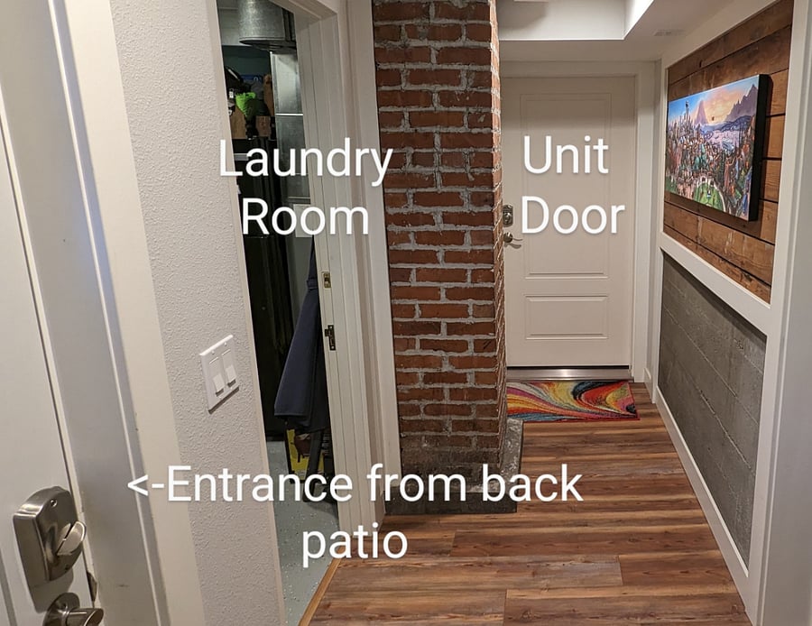 Entrance from back patio to shared hallway to unit door and shared laundry room