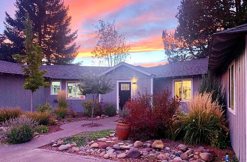 Natural landscape and river rock garden welcome you to your comfortable single level home.