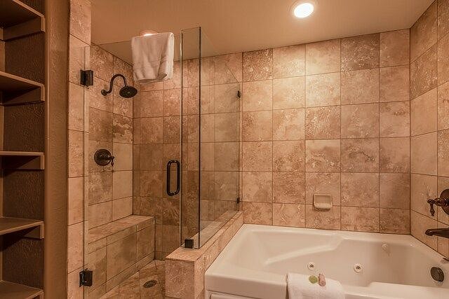 Oversized jetted tub and separate shower stall.