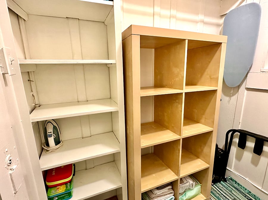 Spacious walk-in closet off the living room with shelving, area to hang clothes and storage