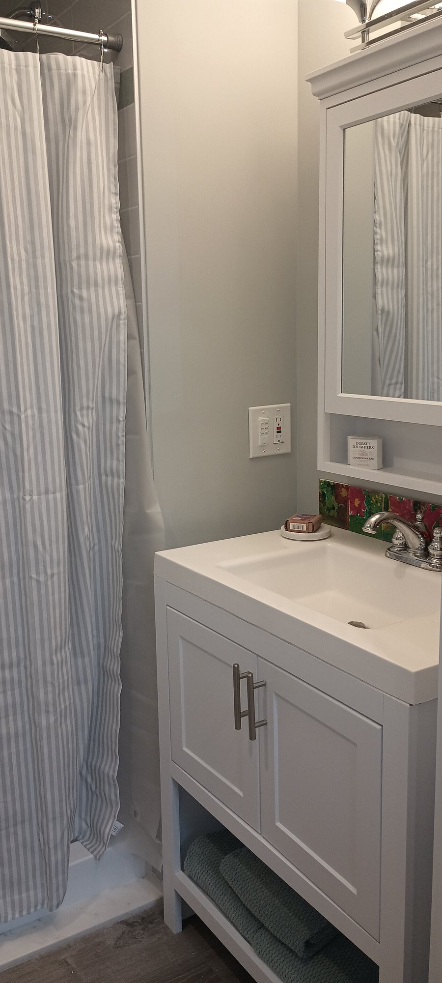 Newly installed shower, bathroom with pocket door for space saving efficiency. Plenty of storage space