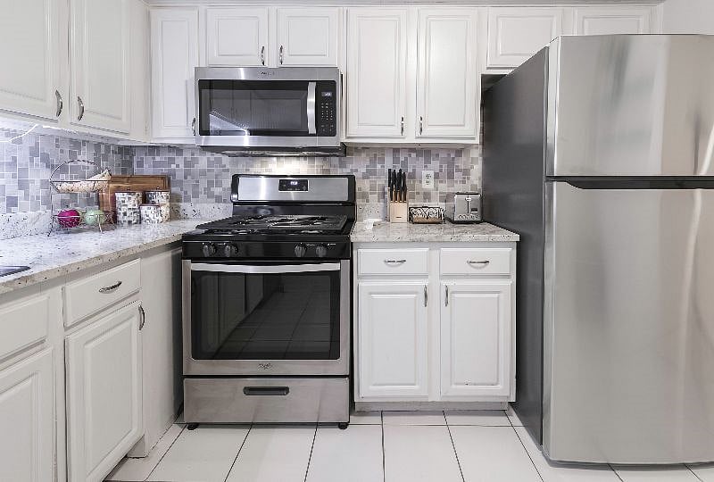Kitchen gas stove and full size fridge