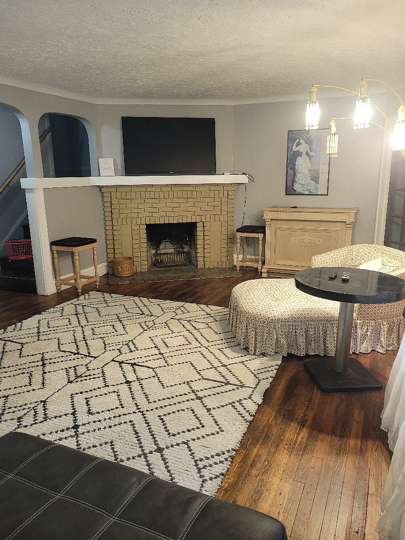 Living Room w/ 65 inch TV and wood burning fireplace.