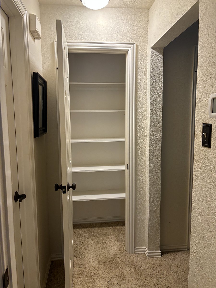 Outside the bedroom are two additional closets; one with shelves and the other for hangup clothes.